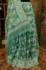 Pastel green cotton jamdani with white and gold floral design weaved all over saree