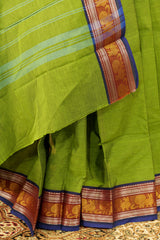 Green shade chettinad cotton saree  with purple borders on both the sides with peacock design in silver and golden weaving