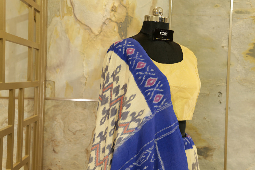 Off-White Ikat Pochampalli handwoven saree with blue border and Pallu