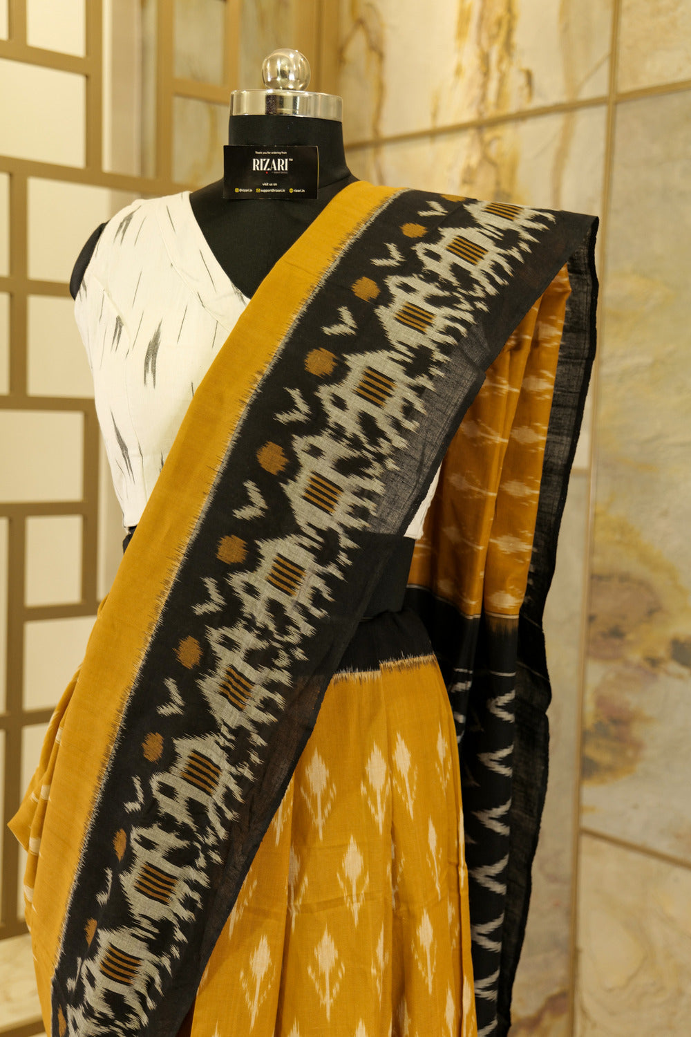 Mustard Ikat Pochampalli  with black border with elephant figurines on border and black Pallu