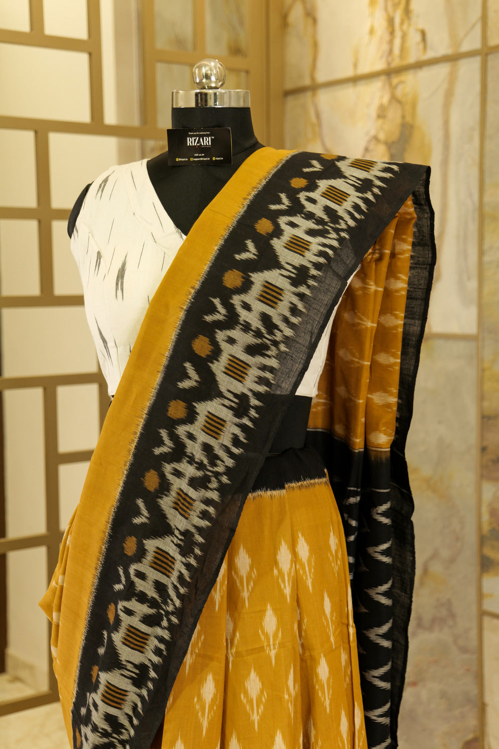 Mustard Ikat Pochampalli  with black border with elephant figurines on border and black Pallu