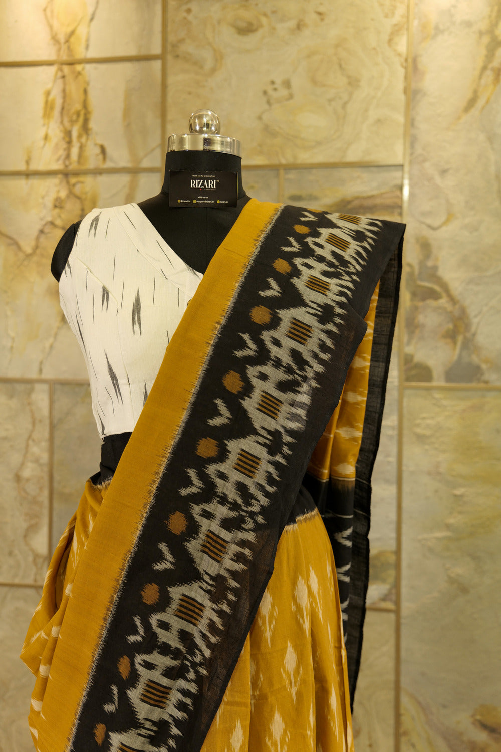 Mustard Ikat Pochampalli  with black border with elephant figurines on border and black Pallu