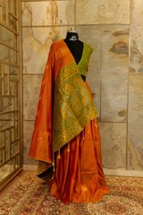 Soft silk orange-mustard shade saree with contrast green brocade Pallu