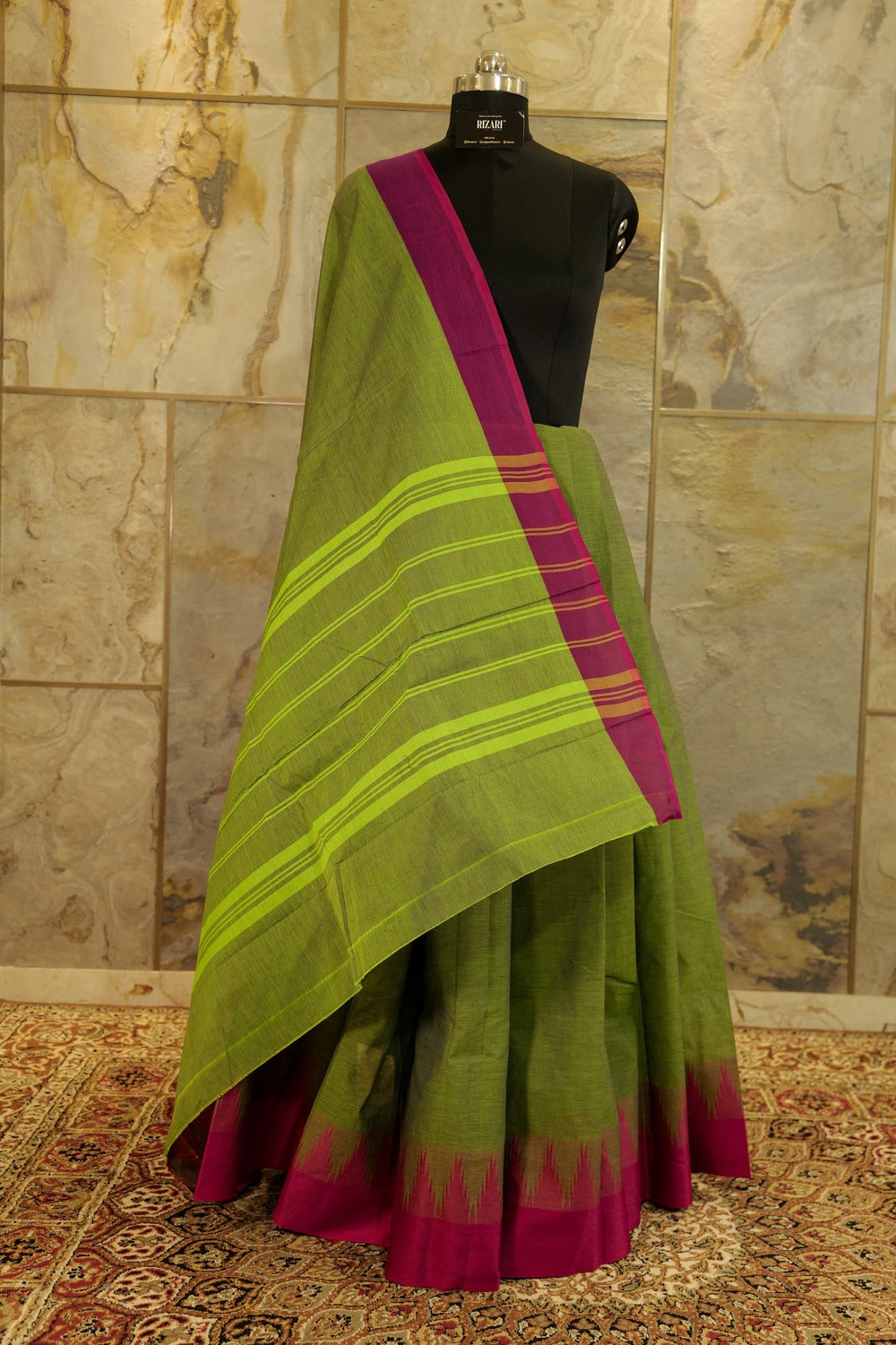 Green chettinad cotton saree with pink contrast border and traditional temple design on one side