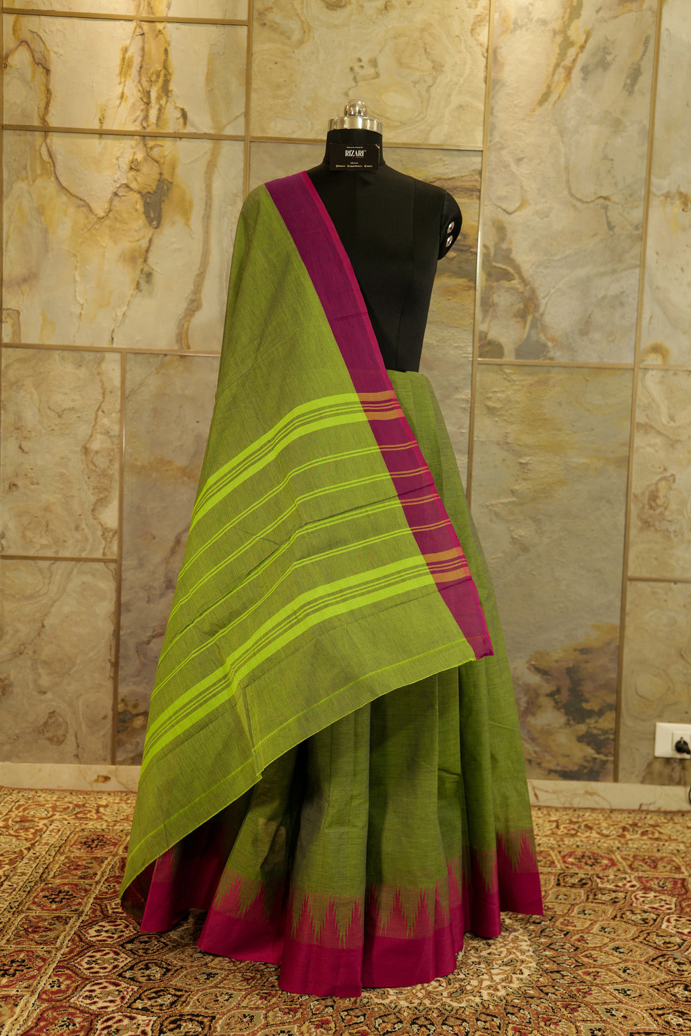 Green chettinad cotton saree with pink contrast border and traditional temple design on one side