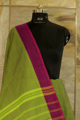 Green chettinad cotton saree with pink contrast border and traditional temple design on one side