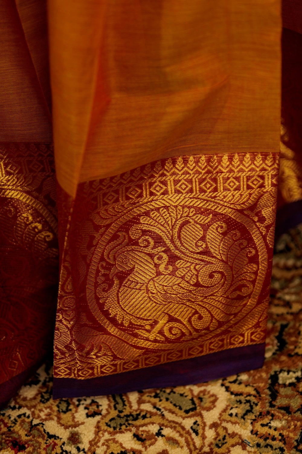 Brown-purple dual tones chettinad cotton saree with dark brown border on one side with bird figure woven inside a circle