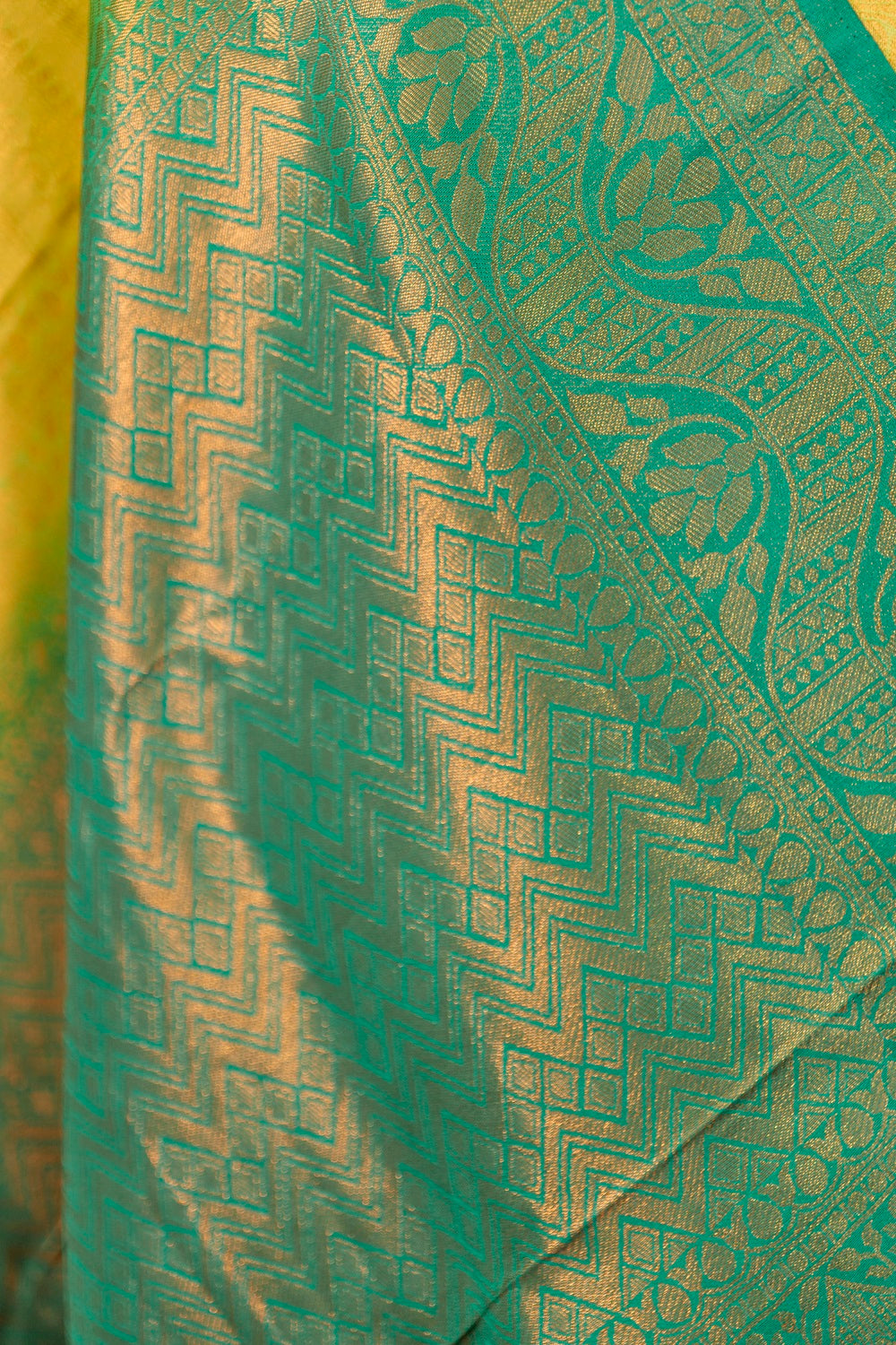 Yellow banarasi with contrast teal green rich brocade Pallu and plain teal green blouse .