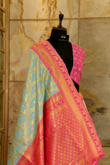 pastel blue soft banarasi pattern saree with woven peacock motifs all over - pink contrast Pallu and border